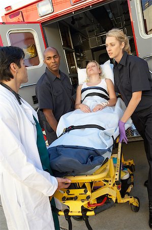 Paramedics and doctor unloading patient from ambulance Stock Photo - Budget Royalty-Free & Subscription, Code: 400-04890177