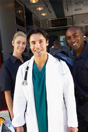 Doctor and paramedics standing in front of an ambulance Stock Photo - Budget Royalty-Free & Subscription, Code: 400-04890170
