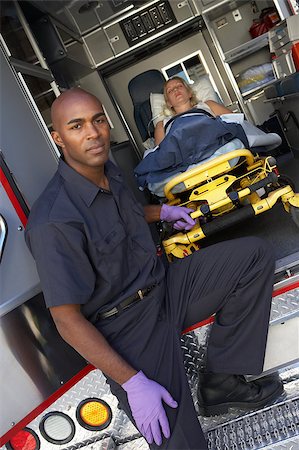 simsearch:400-04890175,k - Male paramedic preparing to unload patient from ambulance Stock Photo - Budget Royalty-Free & Subscription, Code: 400-04890172