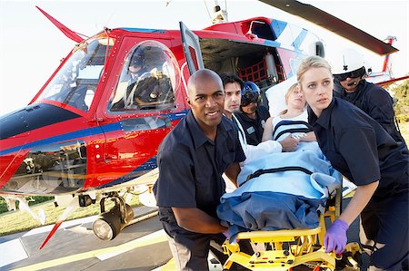 Paramedics unloading patient from Medevac Stock Photo - Budget Royalty-Free & Subscription, Code: 400-04890184