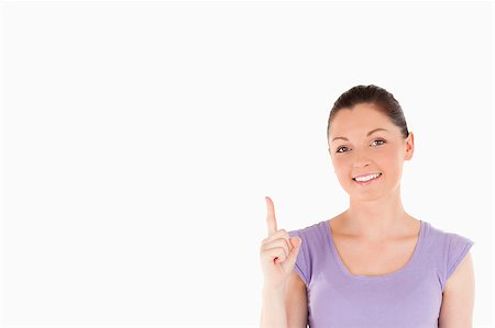 simsearch:400-04925223,k - Beautiful female pointing at a copy space against a white background Stock Photo - Budget Royalty-Free & Subscription, Code: 400-04890523