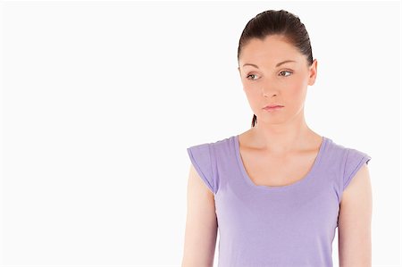 simsearch:400-05263438,k - Unhappy woman posing while standing against a white background Stock Photo - Budget Royalty-Free & Subscription, Code: 400-04890594