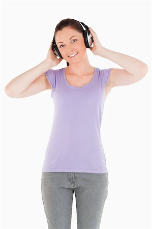 simsearch:400-06690896,k - Good looking woman posing with headphones while standing against a white background Stock Photo - Budget Royalty-Free & Subscription, Code: 400-04890807