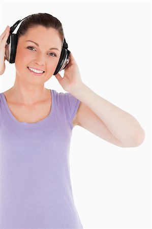 simsearch:400-06690896,k - Attractive female posing with headphones while standing against a white background Stock Photo - Budget Royalty-Free & Subscription, Code: 400-04890815