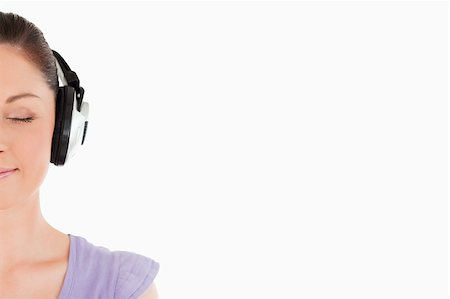 simsearch:400-06690896,k - Portrait of an attractive woman posing with headphones while standing against a white background Stock Photo - Budget Royalty-Free & Subscription, Code: 400-04890819