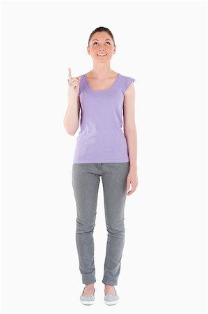 simsearch:400-04925223,k - Attractive woman pointing at a copy space against a white background Stock Photo - Budget Royalty-Free & Subscription, Code: 400-04890831
