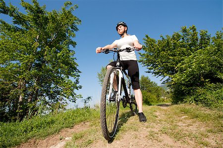 simsearch:400-04890875,k - Young girl riding a bike on a field path - offroad Stock Photo - Budget Royalty-Free & Subscription, Code: 400-04890874