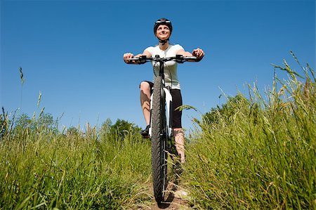 simsearch:400-04890875,k - Young girl riding a bike on a field path - offroad Stock Photo - Budget Royalty-Free & Subscription, Code: 400-04890875