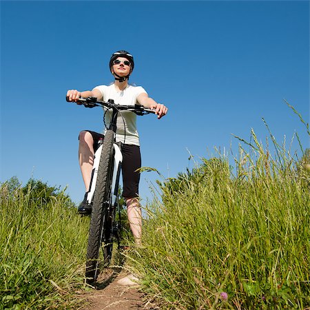 simsearch:400-04890875,k - Young girl riding a bike on a field path - offroad Stock Photo - Budget Royalty-Free & Subscription, Code: 400-04890877
