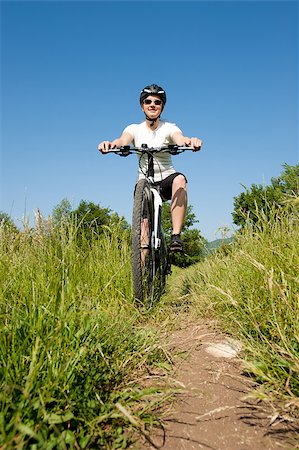 simsearch:400-04890875,k - Young girl riding a bike on a field path - offroad Stock Photo - Budget Royalty-Free & Subscription, Code: 400-04890879