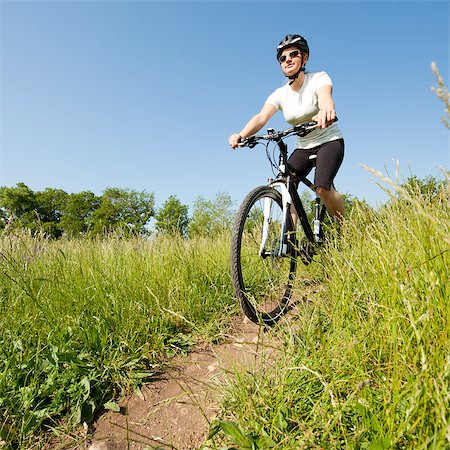 simsearch:400-04890875,k - Young girl riding a bike on a field path - offroad Stock Photo - Budget Royalty-Free & Subscription, Code: 400-04890880
