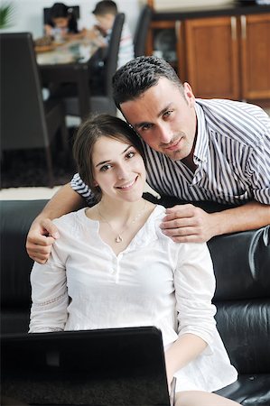 joyful couple relax and work on laptop computer at modern livingroom indoor home Stock Photo - Budget Royalty-Free & Subscription, Code: 400-04891380