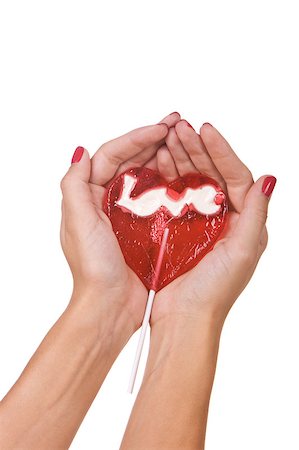 Heart shape lollipop in a hand isolated over white background Stock Photo - Budget Royalty-Free & Subscription, Code: 400-04892083