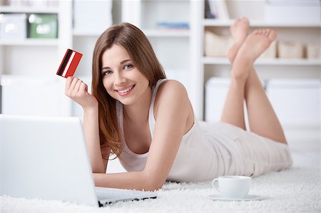 Young girl with laptop and credit card at home Stock Photo - Budget Royalty-Free & Subscription, Code: 400-04892208