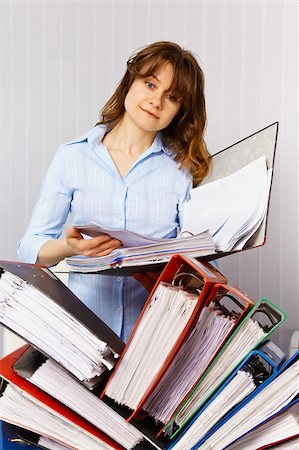 examination folder - Female accountant reflects on the financial documentation Stock Photo - Budget Royalty-Free & Subscription, Code: 400-04892287