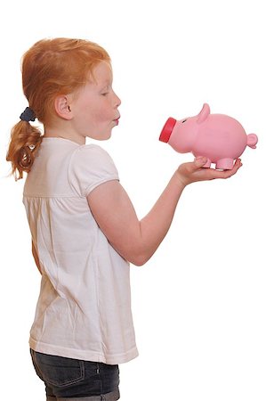 Portrait of a red heired girl trying to kiss her piggy bank on white background Stock Photo - Budget Royalty-Free & Subscription, Code: 400-04892926