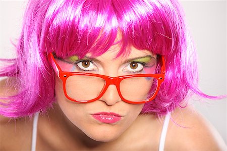 simsearch:400-05745991,k - A picture of a young serious woman in purple hair and colorful make-up over light background Foto de stock - Super Valor sin royalties y Suscripción, Código: 400-04893365