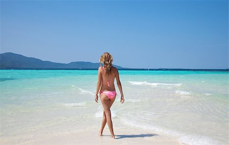 Young woman walking at a tropical turquoise beach Stock Photo - Budget Royalty-Free & Subscription, Code: 400-04893607