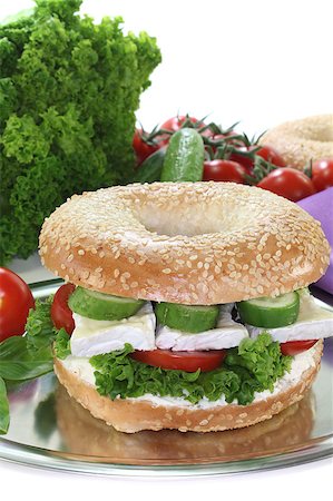 Bagel with Camembert cheese, tomato, cucumber, cream cheese and lettuce on white background Photographie de stock - Aubaine LD & Abonnement, Code: 400-04893815