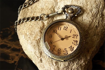 pocket watch - A macro shot of an antique pocket watch on a textured rock. Stock Photo - Budget Royalty-Free & Subscription, Code: 400-04904168
