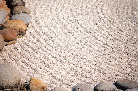 A Zen garden makes symbolic representations of natural landscapes using stone arrangements, white sand raked that symbolizes sea, ocean, rivers or lakes. Stock Photo - Budget Royalty-Free & Subscription, Code: 400-04904235