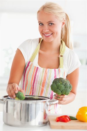 simsearch:400-08021946,k - Portrait of a smiling woman putting cabbage on water while looking at the camera Stock Photo - Budget Royalty-Free & Subscription, Code: 400-04904427