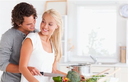 In love couple cooking in their kitchen Stock Photo - Budget Royalty-Free & Subscription, Code: 400-04904477