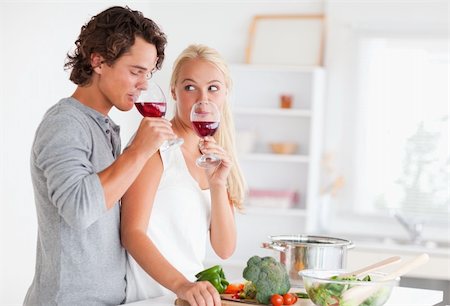 Couple drinking a glass of red wine in their kitchen Stock Photo - Budget Royalty-Free & Subscription, Code: 400-04904483