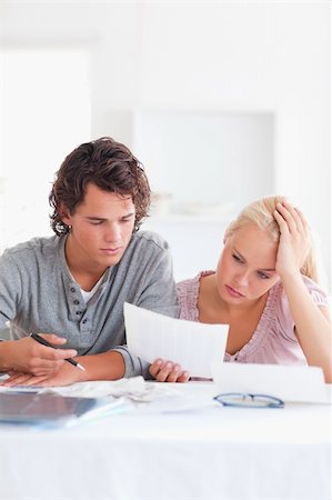 Worried Couple with Paperwork in their living room Stock Photo - Budget Royalty-Free & Subscription, Code: 400-04904550