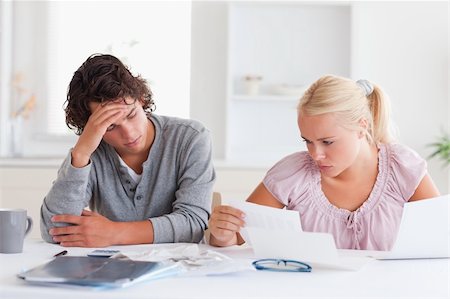 Worried couple doing paperwork in their living room Stock Photo - Budget Royalty-Free & Subscription, Code: 400-04904561