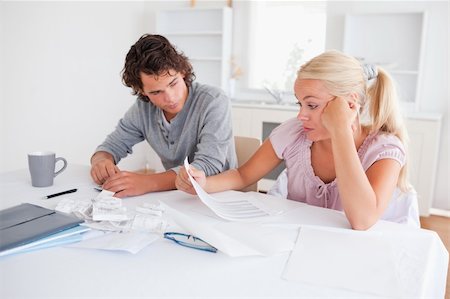 Stressed couple doing accounts in their living room Stock Photo - Budget Royalty-Free & Subscription, Code: 400-04904602