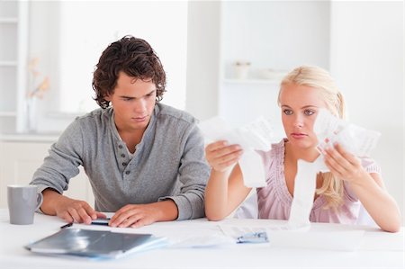 Couple in despaira doing their accounts in a living room Stock Photo - Budget Royalty-Free & Subscription, Code: 400-04904649