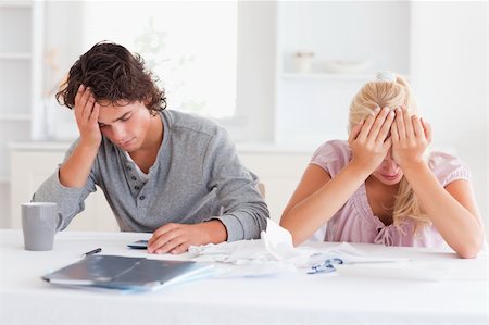 Sad couple while accounting in their living room Stock Photo - Budget Royalty-Free & Subscription, Code: 400-04904660