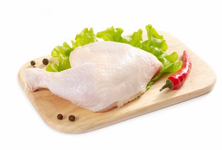 raw chicken on cutting board - fresh raw chicken leg and vegetables on a wooden cutting board Stock Photo - Budget Royalty-Free & Subscription, Code: 400-04904673