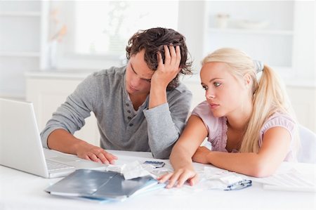Worn out couple doing their accounting in their living room Stock Photo - Budget Royalty-Free & Subscription, Code: 400-04904753