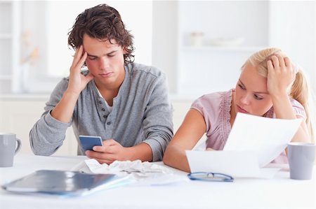 Couple going through their expenses in their living room Stock Photo - Budget Royalty-Free & Subscription, Code: 400-04904763