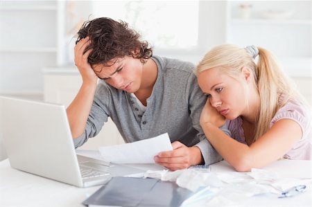 Tired couple doing their accounts in their living room Stock Photo - Budget Royalty-Free & Subscription, Code: 400-04904775