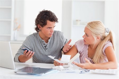 Clueless couple doing accounts in their living room Stock Photo - Budget Royalty-Free & Subscription, Code: 400-04904817