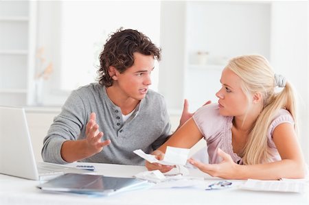 Couple arguing on expenses in their living room Stock Photo - Budget Royalty-Free & Subscription, Code: 400-04904849