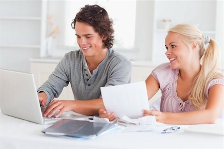 Happy couple accounting in their living room Stock Photo - Budget Royalty-Free & Subscription, Code: 400-04904872