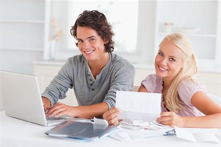 Confident couple accounting in their living room Stock Photo - Budget Royalty-Free & Subscription, Code: 400-04904894