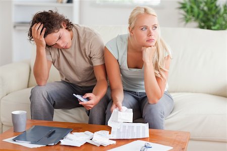 Couple figuring out what to do sitting in the livingroom Stock Photo - Budget Royalty-Free & Subscription, Code: 400-04904926