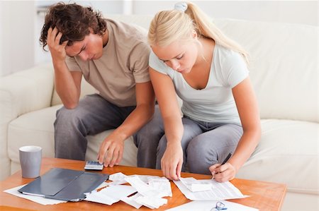 simsearch:400-05746763,k - Worn out couple working together in the living room Stock Photo - Budget Royalty-Free & Subscription, Code: 400-04904929