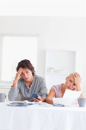 Worn out couple calculating their expenses in the living room Stock Photo - Budget Royalty-Free & Subscription, Code: 400-04904921