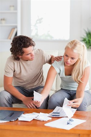 Man comforting his wife while accounting in the living room Stock Photo - Budget Royalty-Free & Subscription, Code: 400-04904922