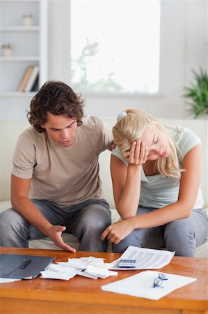 Stressed couple on a sofa in the living room Stock Photo - Budget Royalty-Free & Subscription, Code: 400-04904923