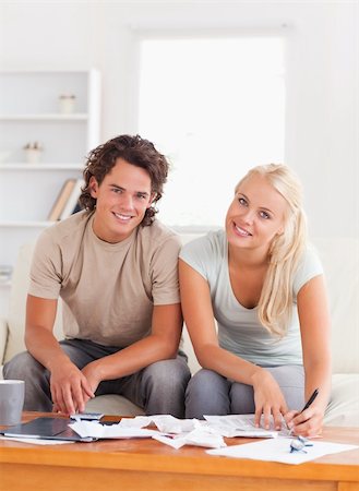 Happy couple calculating in the living room Stock Photo - Budget Royalty-Free & Subscription, Code: 400-04904935