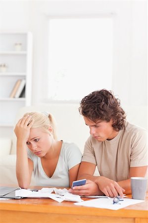 Despaired couple listing expenses in the living room Stock Photo - Budget Royalty-Free & Subscription, Code: 400-04904939