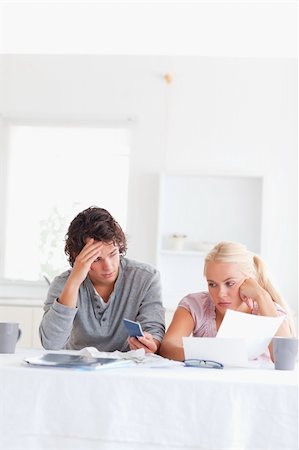 simsearch:400-05746763,k - Despaired couple calculating in their living room Stock Photo - Budget Royalty-Free & Subscription, Code: 400-04904930