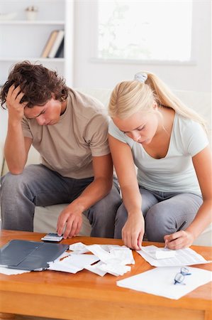 Despaired couple calculating their expenses in the living room Stock Photo - Budget Royalty-Free & Subscription, Code: 400-04904931